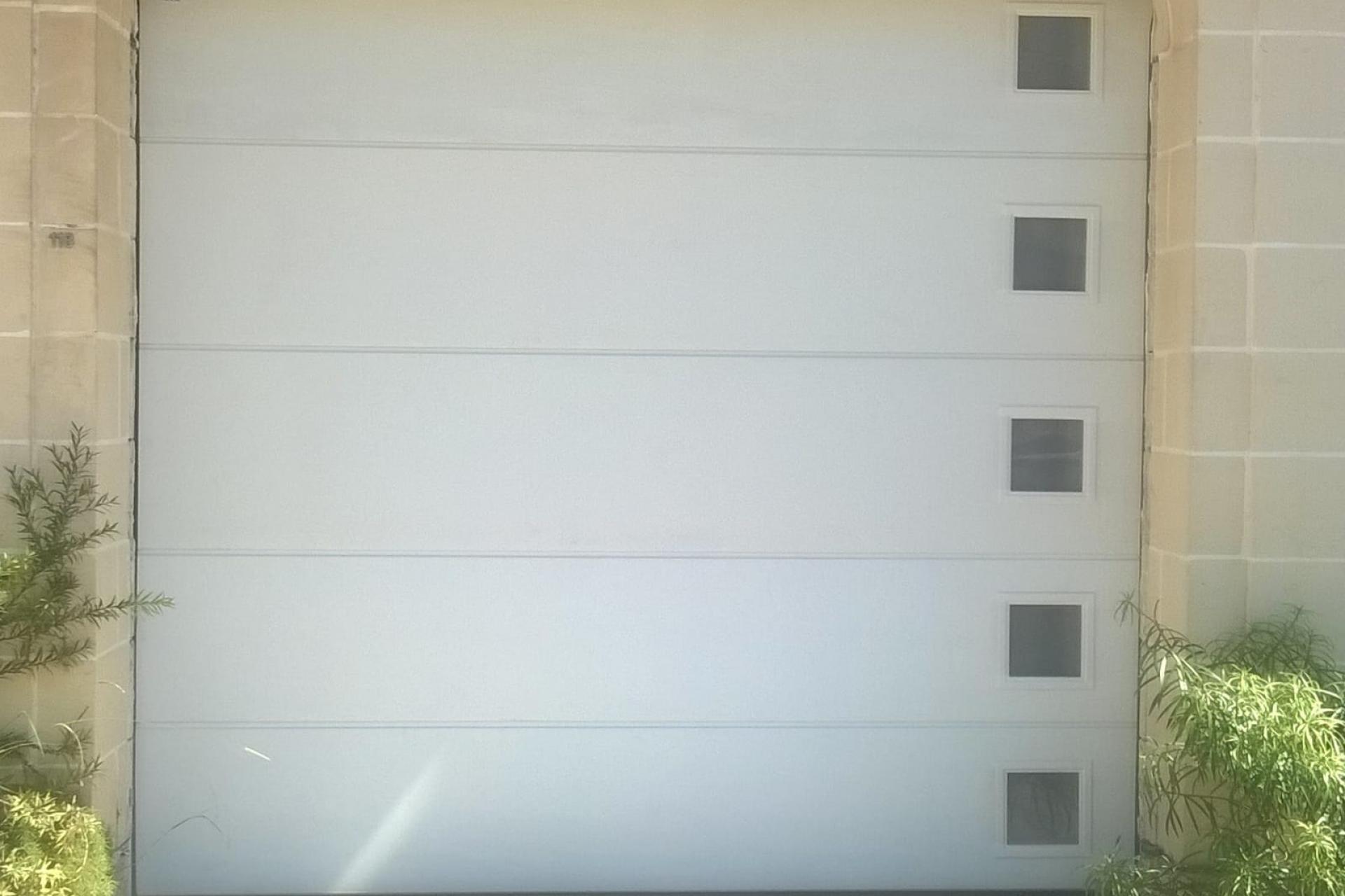 square windows at side, garage doors Malta